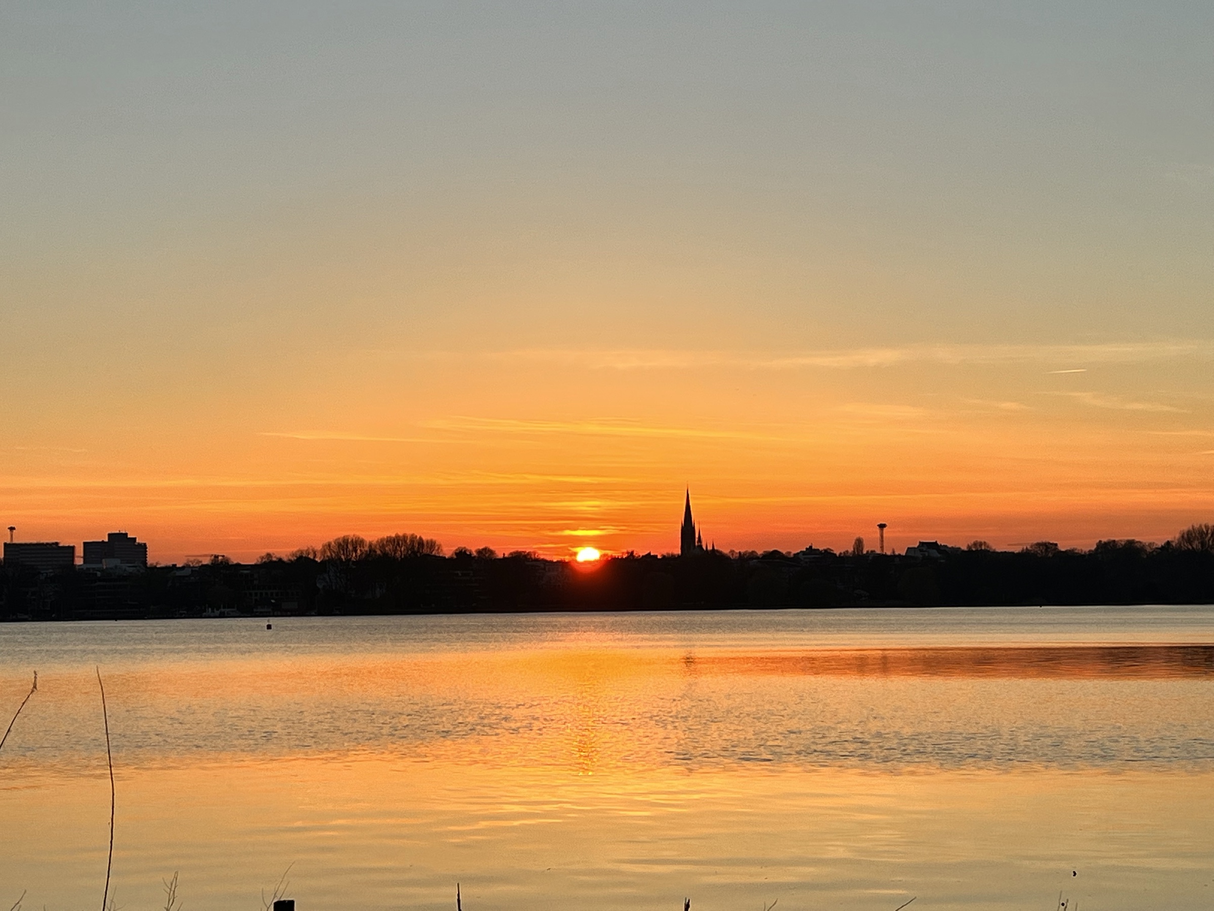 Alster sunset behind a church spire