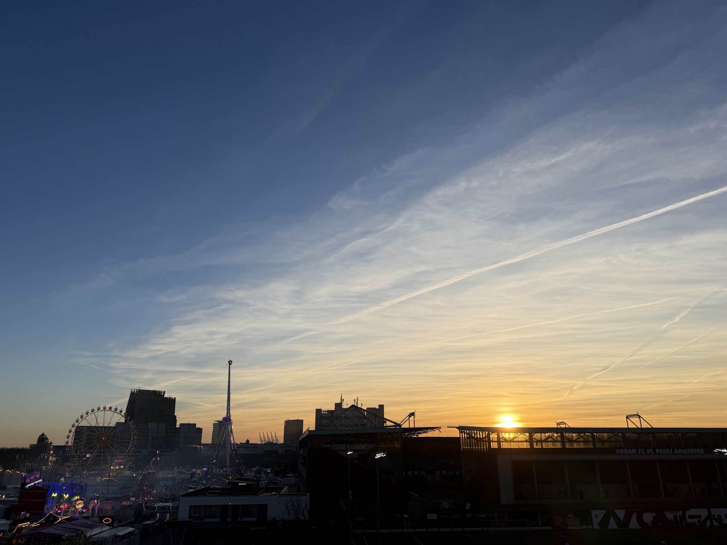 Dom fair at sunset with contrails