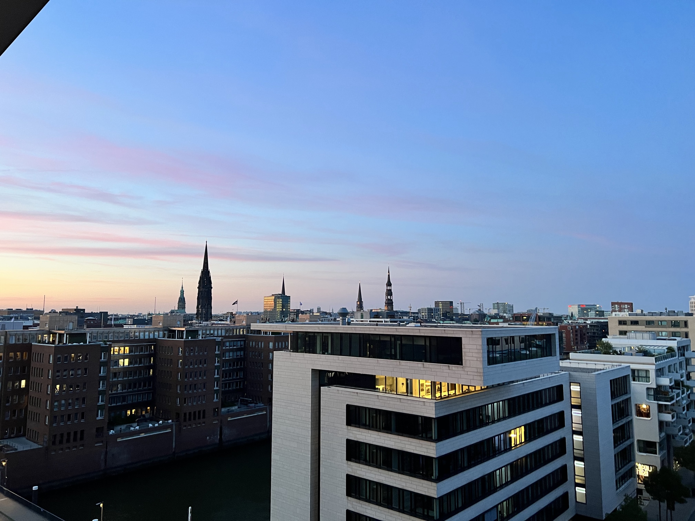Old spires over new HafenCity at pink dusk
